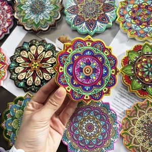 Close-up of bohemian octagonal ceramic coaster with gold mandala pattern