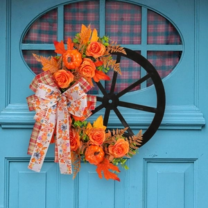 Autumn Thanksgiving wreath with orange roses, pumpkins, and maple leaves on a black wheel