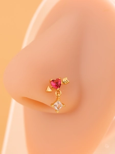 Detail of 18k gold plated nose stud featuring a pink heart and arrow with zircon drop