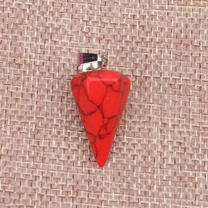 Close-up of red faceted stone cone pendant with black veins and silver metal bail