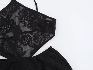 Detailed macro view showing the intricate black lace floral patterns and mesh texture fabric