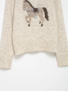 Detail of wool blend knit sweater with horse jacquard pattern and embroidery texture