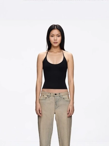 Detailed view of the black halter neck slim fit tank top paired with vintage jeans