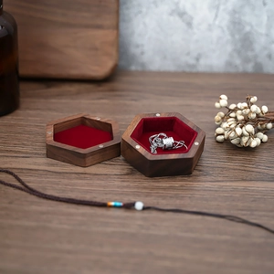 Detail of walnut wood jewelry box with red velvet lining and magnetic closure lid