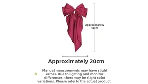 Detail of burgundy satin bow hair clip with 20cm width and 40cm long ribbon tails