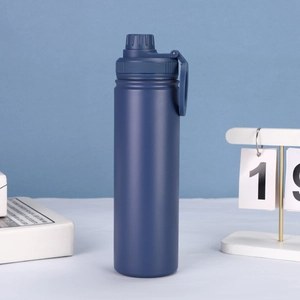 Detail of blue stainless steel insulated sports bottle with magnetic lid and handle