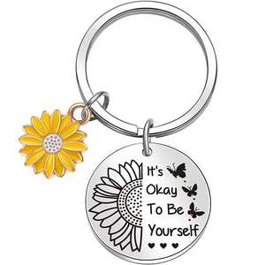 Detail of silver stainless steel keychain with yellow sunflower and It's Okay To Be Yourself text