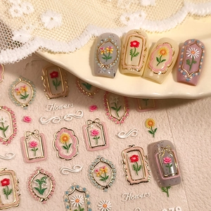 Floral embossed nail stickers with gold rose and daisy patterns for French manicures