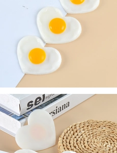 Close-up of heart-shaped fried egg charm made of resin showing smooth texture and details
