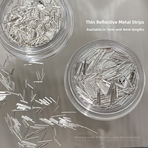 Macro shot of silver reflective nail metal strips in 4mm and 7mm lengths and 0.5mm thickness