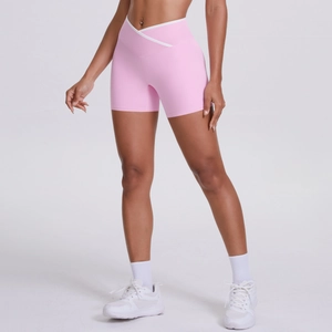 Close-up of crossover V-waist yoga shorts with white contrast piping in pink
