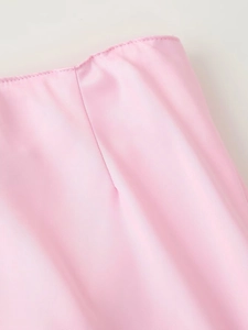Detail of pink satin fabric texture and premium stitching on the skirt and blazer set
