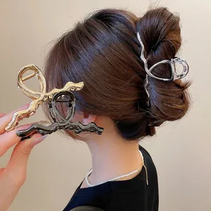 Minimalist metallic wave hair claw clips in gold, silver and gun black for women