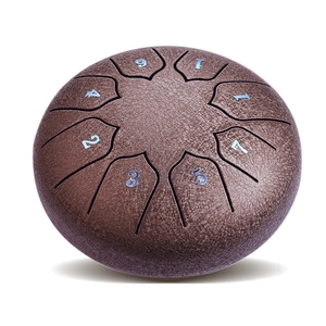 Close-up of brown steel tongue drum with textured surface and eight numeric note markers