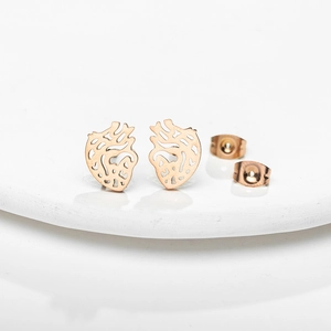 Vintage rose gold hollow anatomical heart stud earrings on a white display stand