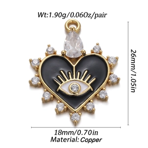 Detail of heart evil eye pendant in black enamel and gold copper with zircon accents