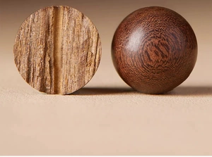 Macro shot showing the natural wood grain and polished texture of Nanmu prayer beads