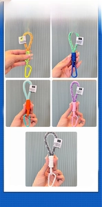 Close-up of colorful braided mesh keychains with metallic D-ring buckles and fabric labels