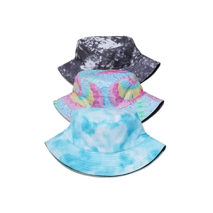 Three tie-dye gradient bucket hats in grey, colorful, and blue for summer sun protection