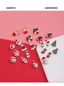 Detailed close-up of colorful Christmas stud earrings with Santa and snowman designs