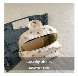 Macro view of floral pattern backpack showing spacious interior storage capacity
