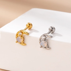 Detailed view of moon-shaped screw back earrings in gold and silver with colorful zircon
