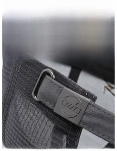 Close-up of adjustable metal buckle and breathable ripstop fabric on a men's baseball cap