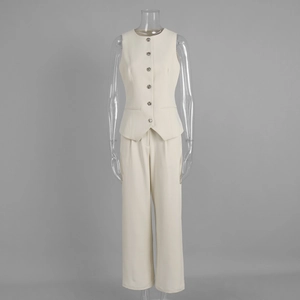 Detail of off-white suit vest featuring six silver embossed buttons and side pockets