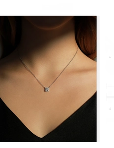 Detail of s925 silver cushion cut moissanite pendant on a delicate chain