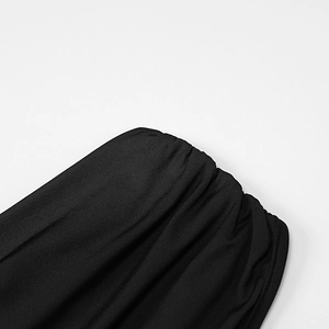 Detail shot of the elastic ruching and high-stretch fabric texture on a black dress
