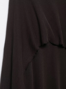 Close-up of dark brown knit fabric showing ruffled layers and texture detail