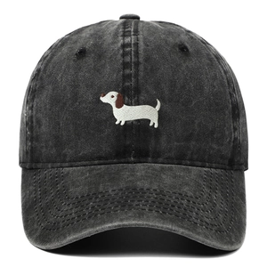 Close-up of embroidered white dachshund dog on washed black vintage denim baseball cap