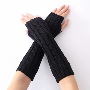 Close-up of black cable-knit long fingerless gloves showing texture and arm coverage