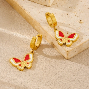 Fashionable gold butterfly earrings with red and white enamel on a natural stone base