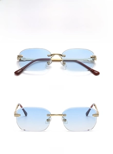 Close-up of rimless square sunglasses with blue gradient lenses and gold diamond temples