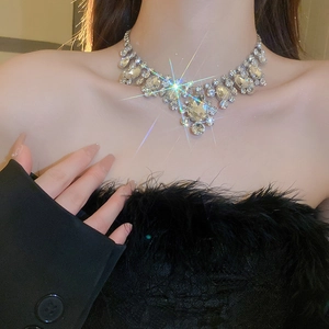 Close-up of sparkling vintage silver tassel necklace with oversized teardrop crystals