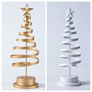 Close-up of gold and silver spiral metal Christmas tree lights with LED star toppers