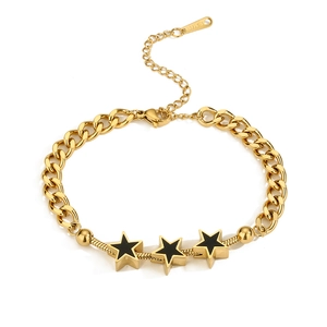 Detail of gold-plated stainless steel bracelet with black shell star charms and beads