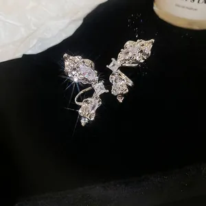 Silver butterfly wing ear cuffs with sparkling zircon stones on black velvet background