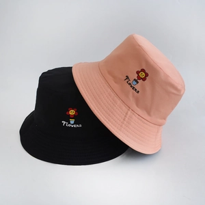 Detailed close-up of sunflower embroidery and Flowers text on cotton bucket hats