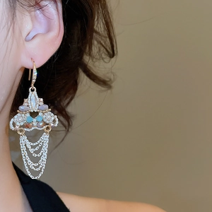 Detailed macro view of vintage gold tassel earrings with colorful sparkling crystals