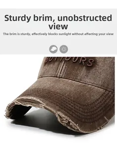 Detail of distressed brown baseball cap featuring embroidered letters and frayed brim design