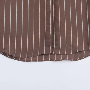 Close-up of brown and white striped shirt hem featuring curved edge and vertical pattern