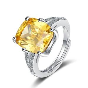 Silver ring featuring a large yellow square zircon and side diamonds with open adjustable band