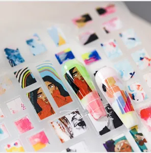 Detailed view of matte nail art stickers with artistic portraits and geometric line designs