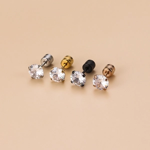 Detail of four pairs of stainless steel stud earrings with zircons and screw backs