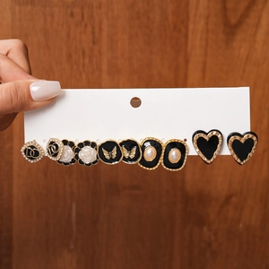 Detail view of vintage French style black and gold earring set on white display card