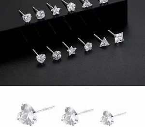 Close-up of S925 silver stud earrings set with heart and star shapes and clear zircons