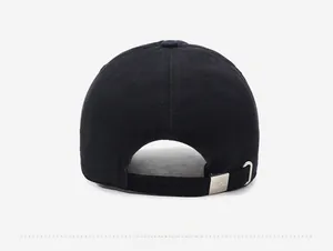 Detail of adjustable metal buckle and stitching on the back of a black cotton baseball cap