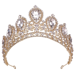 Close-up of golden bridal crown with pear-cut crystals and elegant scroll patterns